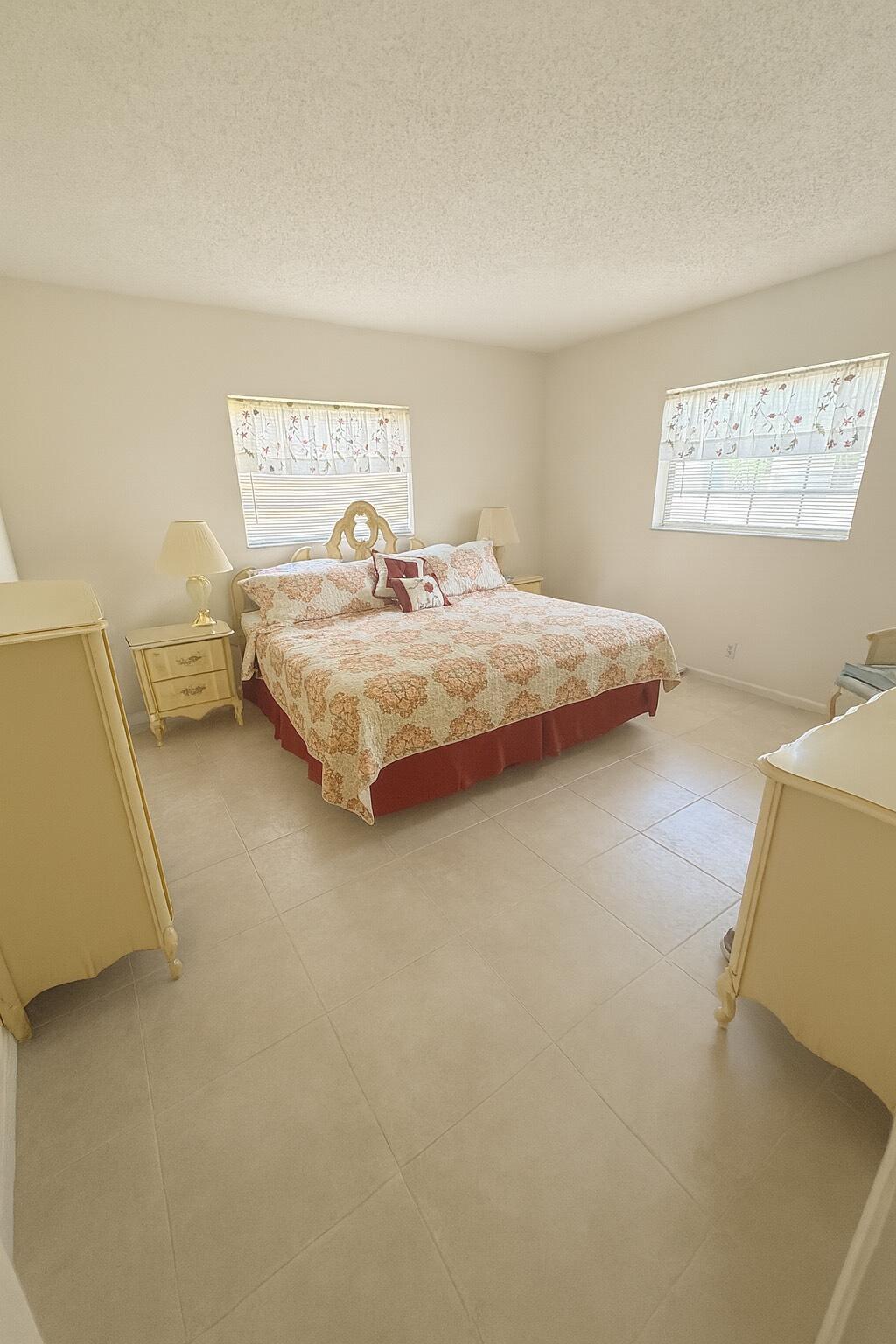 375 Southwest 56th Avenue, Unit 217 Margate, FL 33068 - Photo 4 of 15 a bedroom with a bed and a window