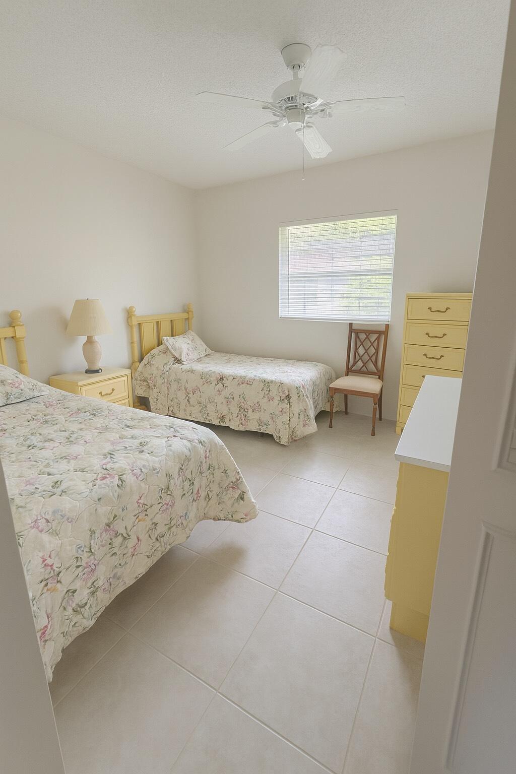 375 Southwest 56th Avenue, Unit 217 Margate, FL 33068 - Photo 5 of 15 a spacious bedroom with a bed and a couch