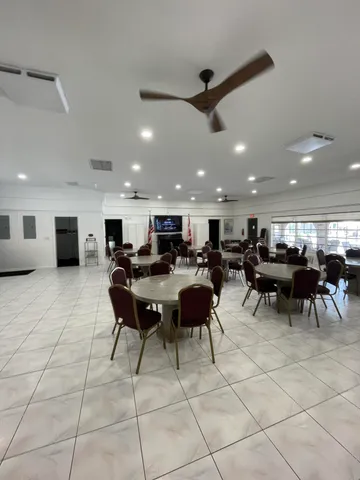 a view of a swimming pool with outdoor seating