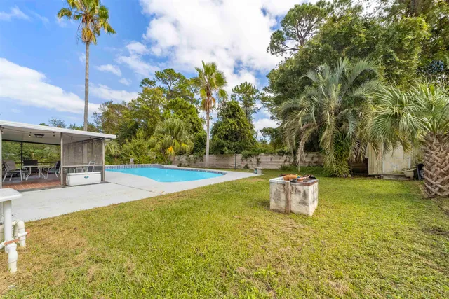 a view of an swimming pool with an outdoor seating and yard