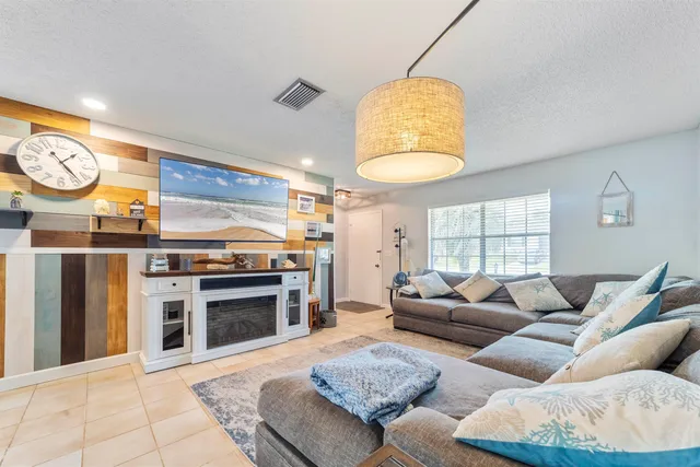 a view of a dining room with furniture a chandelier and wooden floor