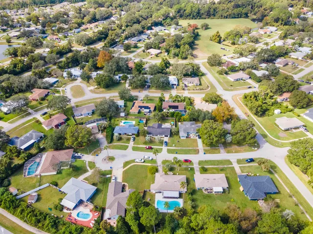 an aerial view of residential houses with outdoor space