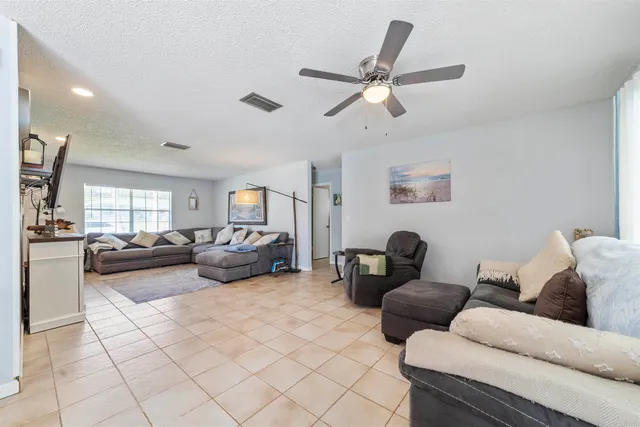 a kitchen with a sink dishwasher stove and cabinets