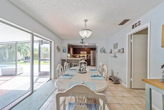 a kitchen with stainless steel appliances granite countertop a refrigerator sink and stove