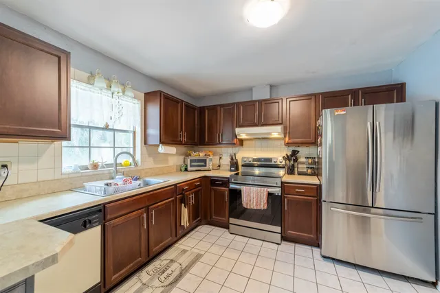 a bedroom with a bed and a tv on the dresser