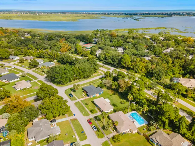 an aerial view of a house with swimming pool garden and patio