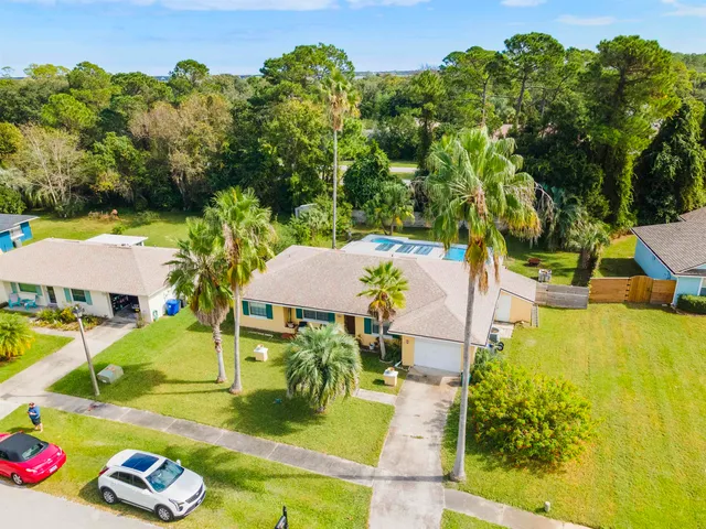 a front view of a house with swimming pool and porch with furniture