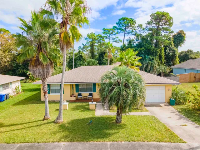 a view of a swimming pool with a lawn chairs under an umbrella