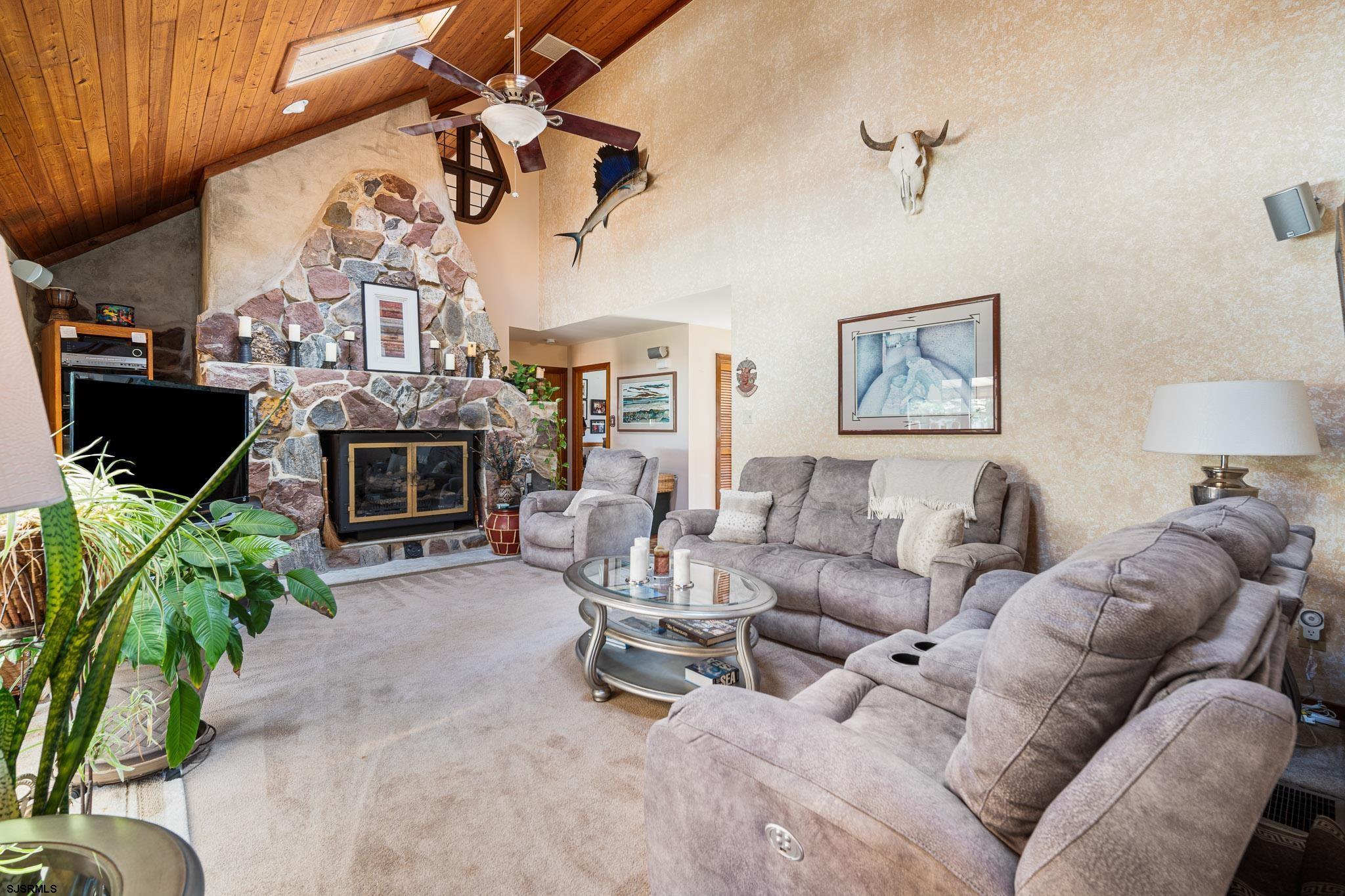 202 North Shore Road Marmora, NJ 08223 - Photo 18 of 31 a living room with furniture a fireplace and a flat screen tv