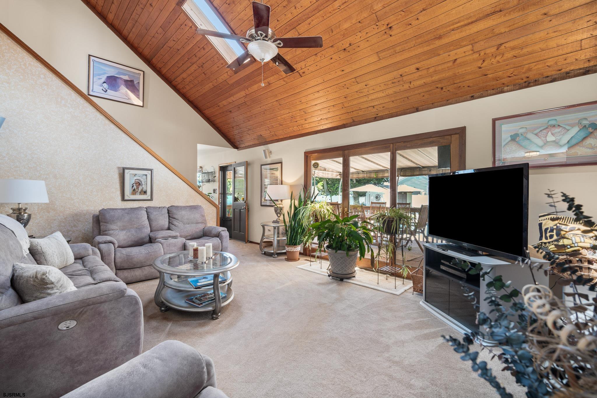 202 North Shore Road Marmora, NJ 08223 - Photo 19 of 31 a living room with furniture and a flat screen tv