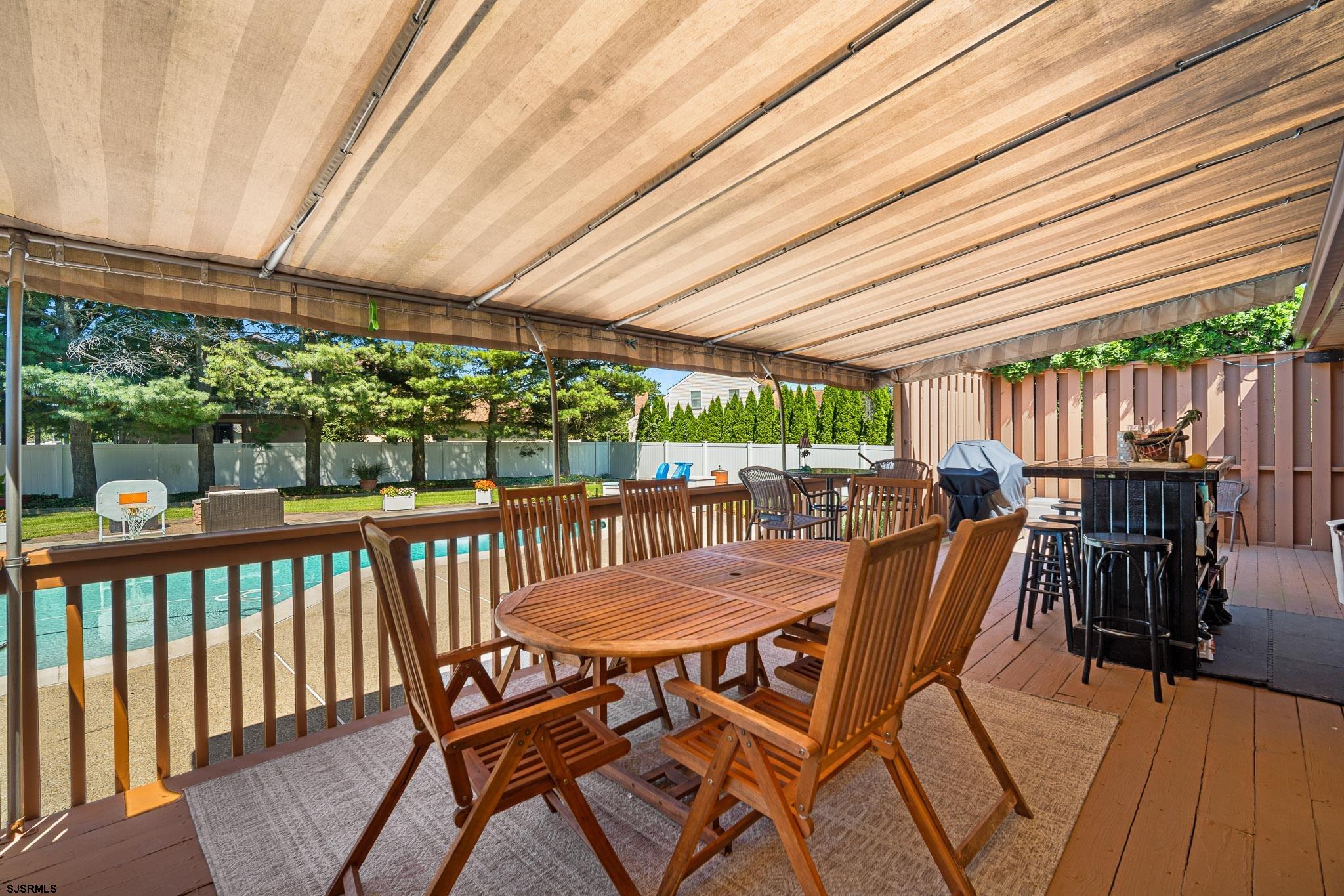 202 North Shore Road Marmora, NJ 08223 - Photo 7 of 31 a view of a patio with table and chairs with wooden floor and fence