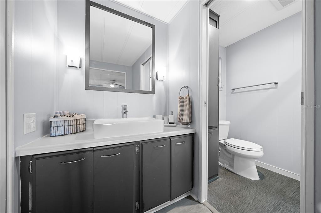 426 Northwest 5th Road Lake Panasoffkee, FL 33538 - Photo 17 of 51 a bathroom with a toilet sink and mirror