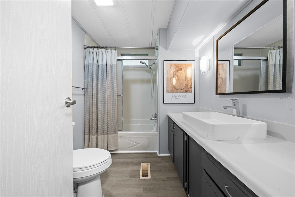 426 Northwest 5th Road Lake Panasoffkee, FL 33538 - Photo 24 of 51 a bathroom with a double vanity sink toilet and shower