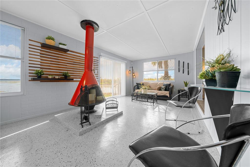 426 Northwest 5th Road Lake Panasoffkee, FL 33538 - Photo 28 of 51 a living room with furniture a window and gym equipment