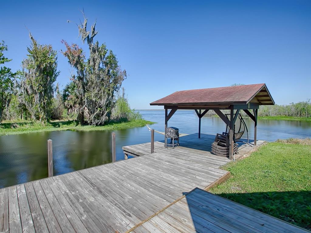 426 Northwest 5th Road Lake Panasoffkee, FL 33538 - Photo 3 of 51 a view of a lake with a table and chairs