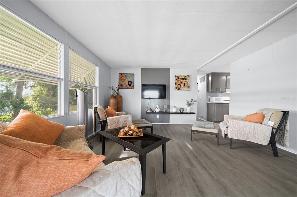 426 Northwest 5th Road Lake Panasoffkee, FL 33538 - Photo 32 of 51 a living room with furniture wooden floor and a large window