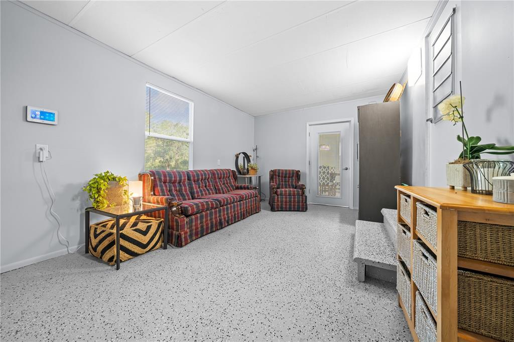 426 Northwest 5th Road Lake Panasoffkee, FL 33538 - Photo 37 of 51 a living room with furniture and a flat screen tv