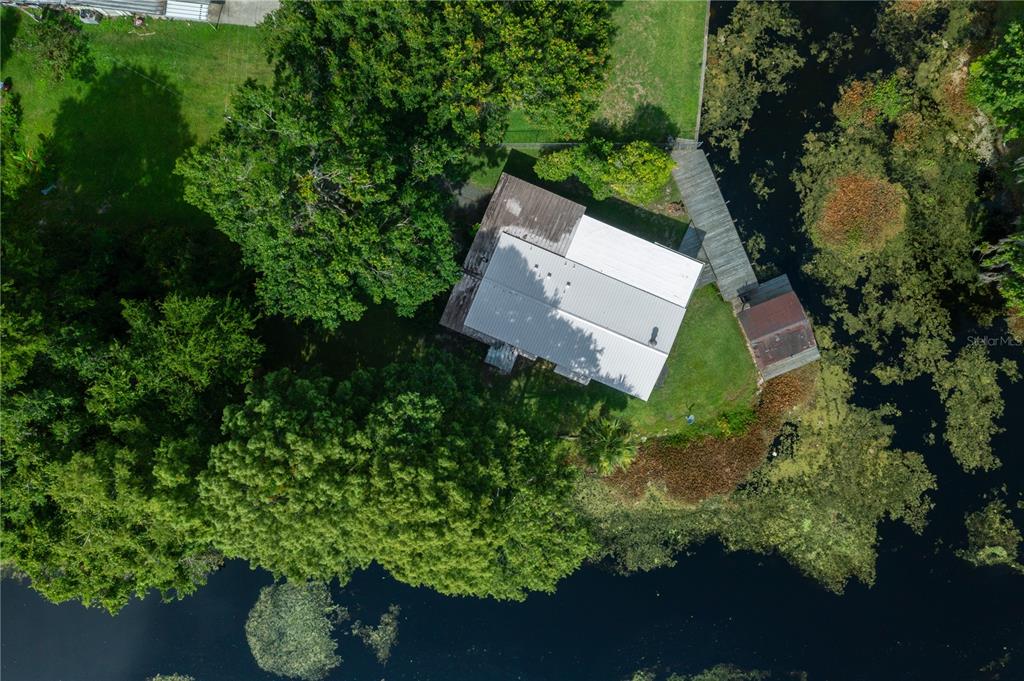 426 Northwest 5th Road Lake Panasoffkee, FL 33538 - Photo 42 of 51 an aerial view of a house with a yard and outdoor seating