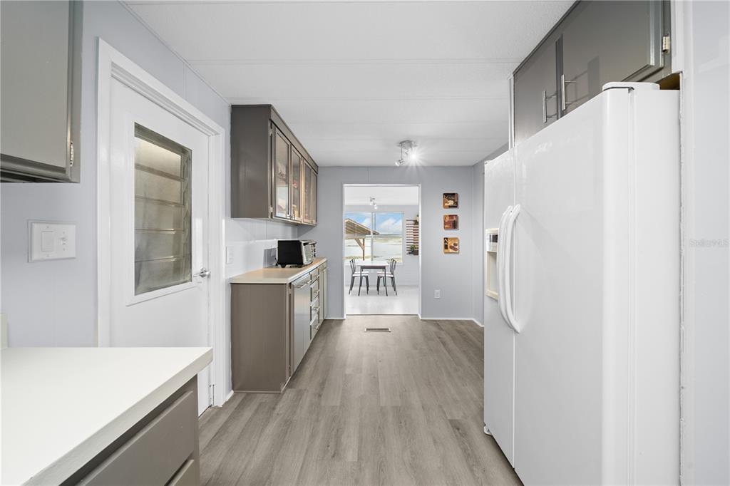 426 Northwest 5th Road Lake Panasoffkee, FL 33538 - Photo 5 of 51 a kitchen with stainless steel appliances a refrigerator and a stove top oven