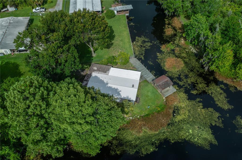 426 Northwest 5th Road Lake Panasoffkee, FL 33538 - Photo 51 of 51 an aerial view of a house with a yard and lake view