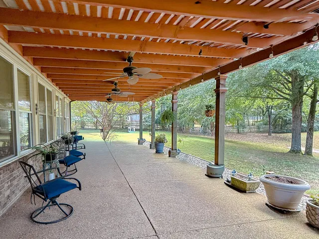 a view of a swimming pool with an outdoor space and seating area