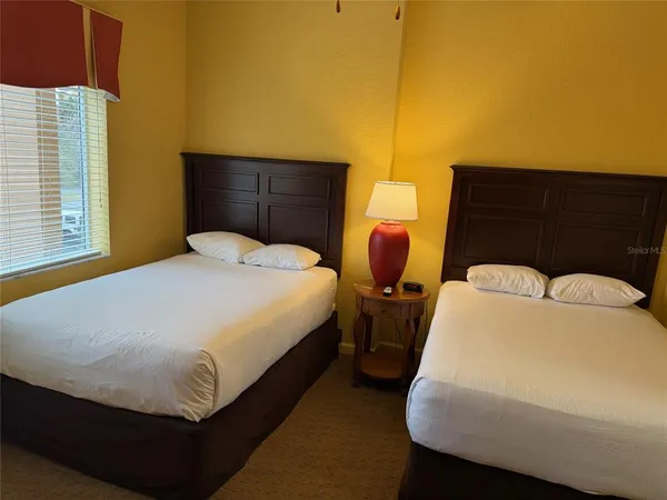 a bathroom with a toilet and a painting on the wall