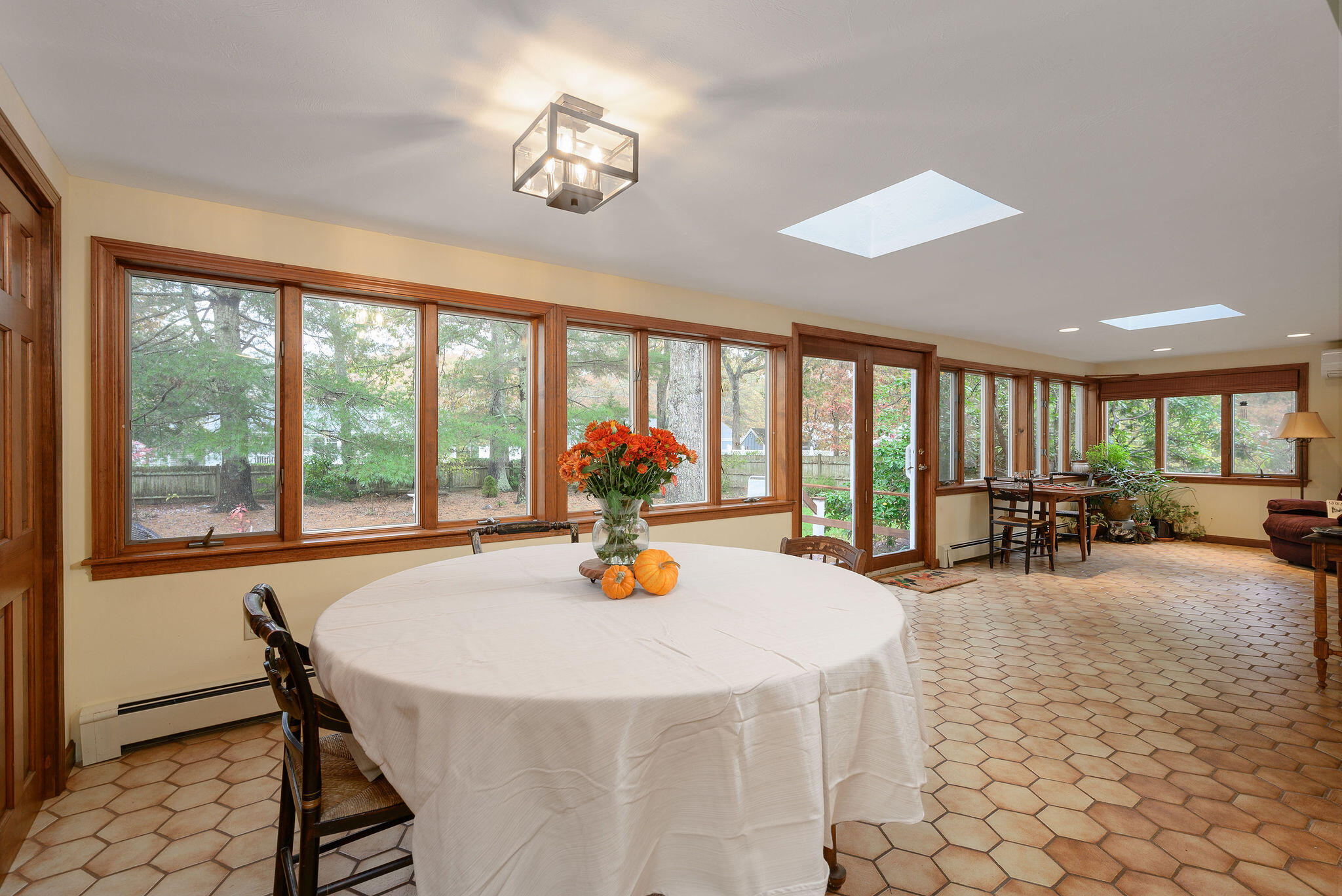 256 Buckskin Path Centerville, MA 02632 - Photo 12 of 38 a view of a dining room with furniture large windows and wooden floor