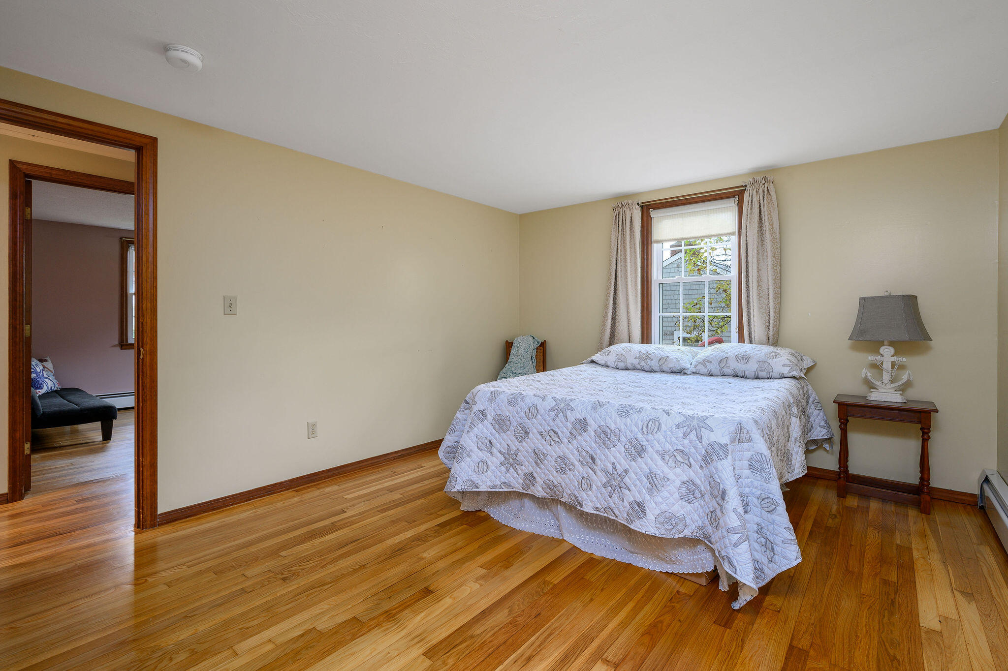256 Buckskin Path Centerville, MA 02632 - Photo 19 of 38 a bedroom with a bed and wooden floor