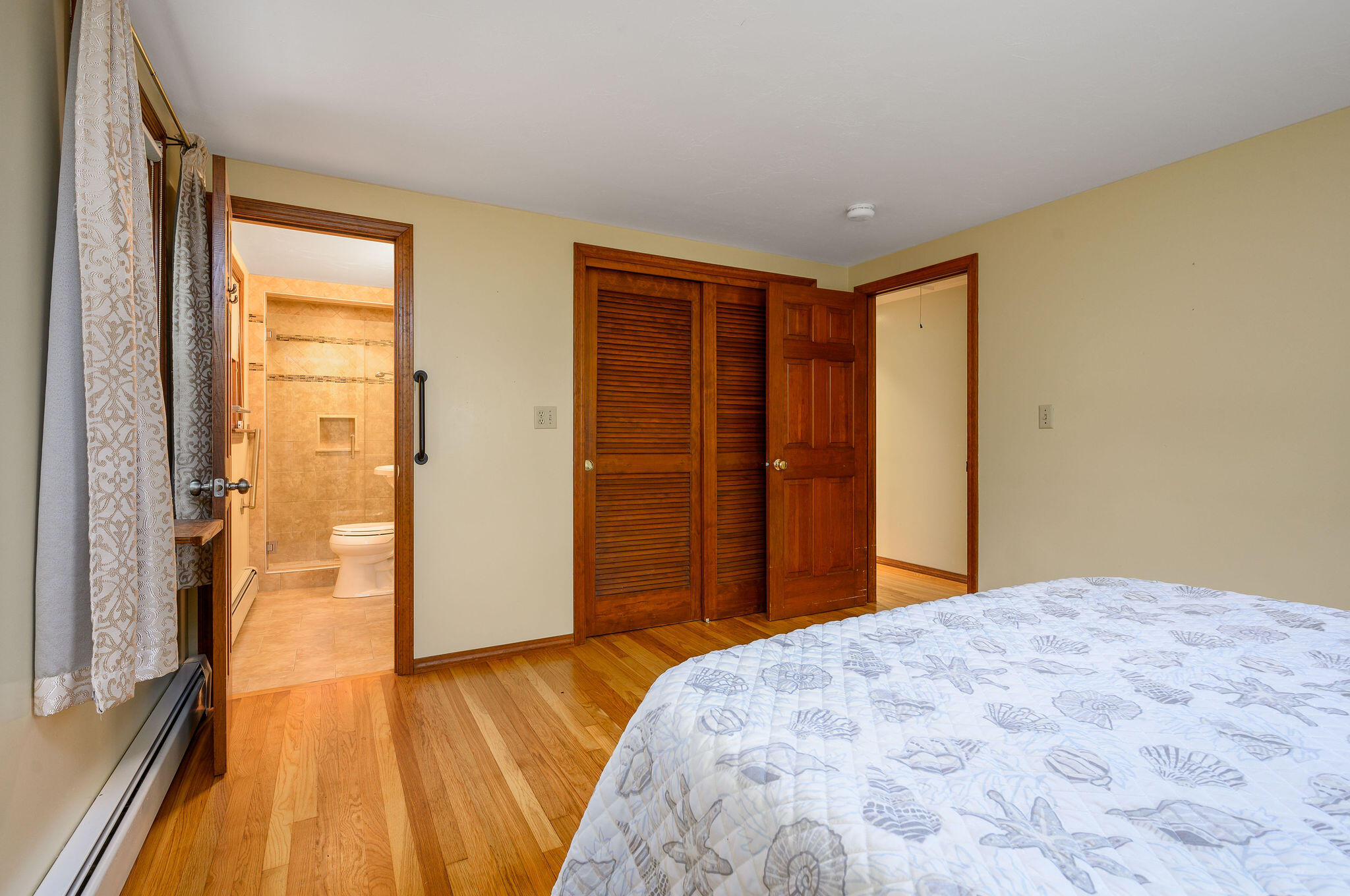 256 Buckskin Path Centerville, MA 02632 - Photo 21 of 38 a bedroom with a bed and wooden floor