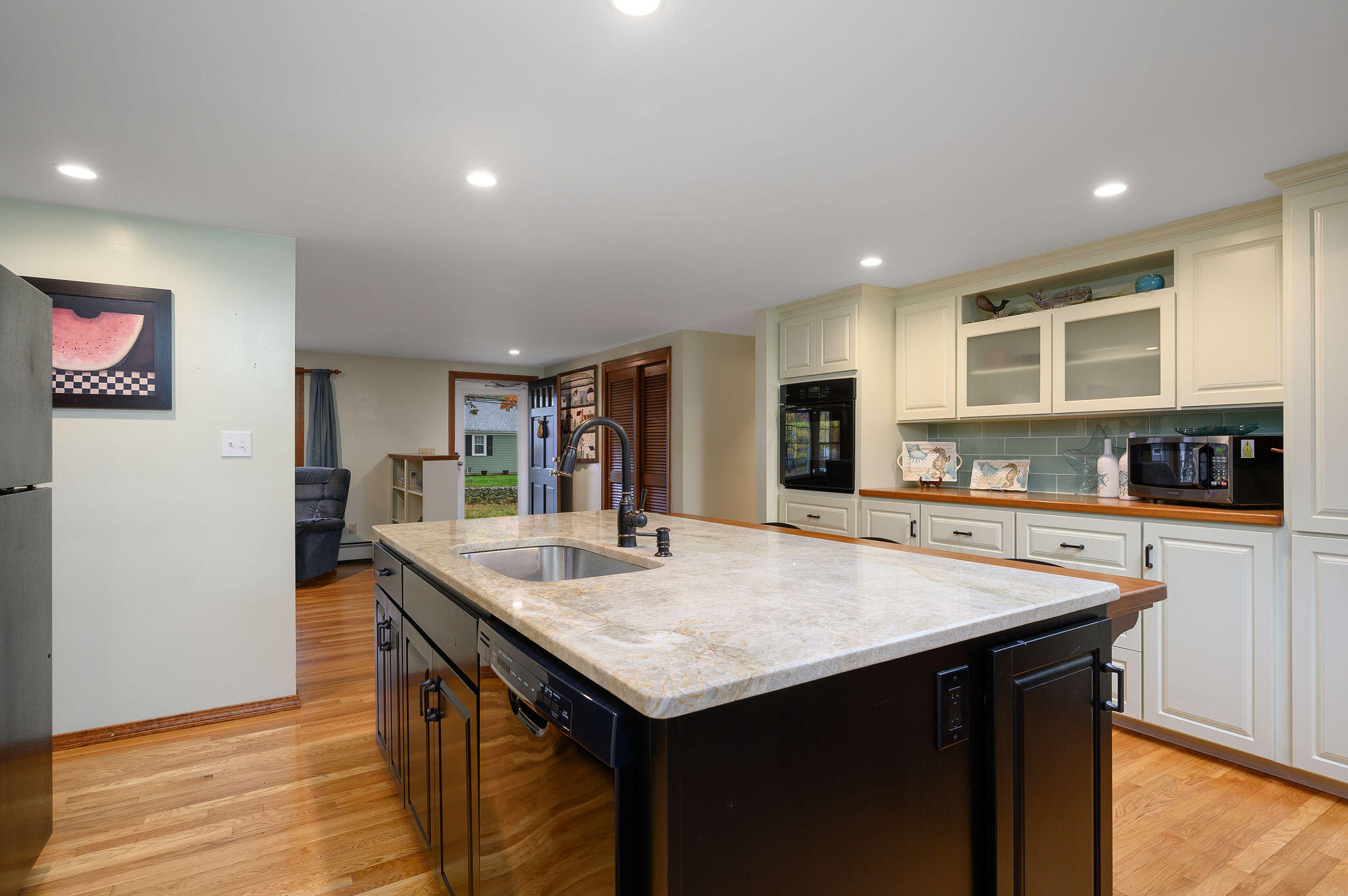 256 Buckskin Path Centerville, MA 02632 - Photo 10 of 38 a view of kitchen island a sink and living room