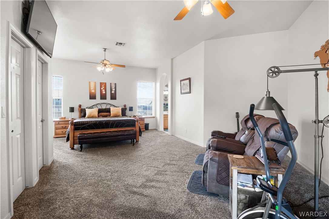 2898 Mountain Trail Road Kingman, AZ 86401 - Photo 15 of 75 a bedroom with furniture and a chandelier