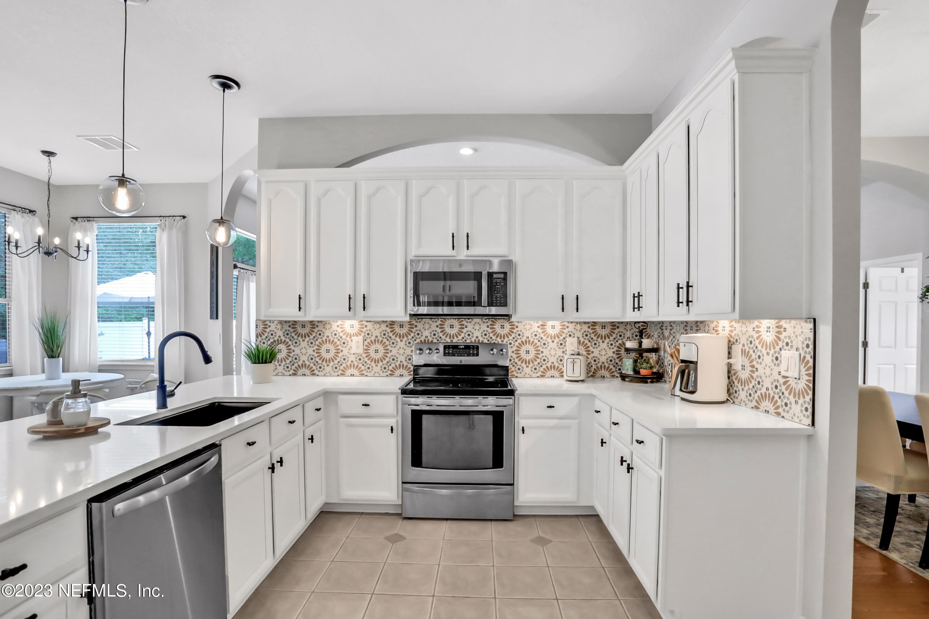 4100 Lonicera Loop St. Johns, FL 32259 - Photo 14 of 65 a kitchen with appliances a sink and cabinets