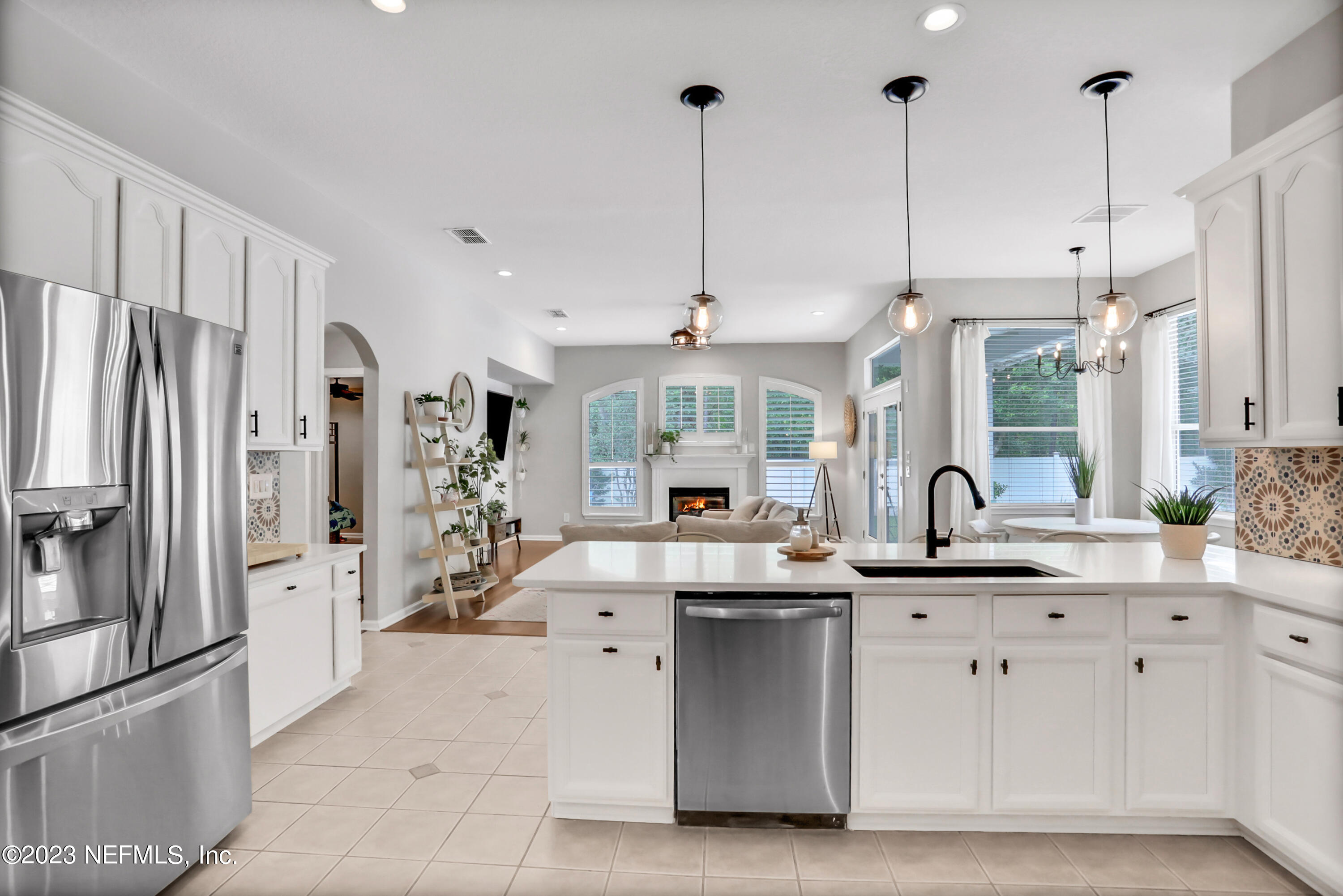 4100 Lonicera Loop St. Johns, FL 32259 - Photo 15 of 65 a kitchen with stainless steel appliances kitchen island granite countertop a sink refrigerator and cabinets