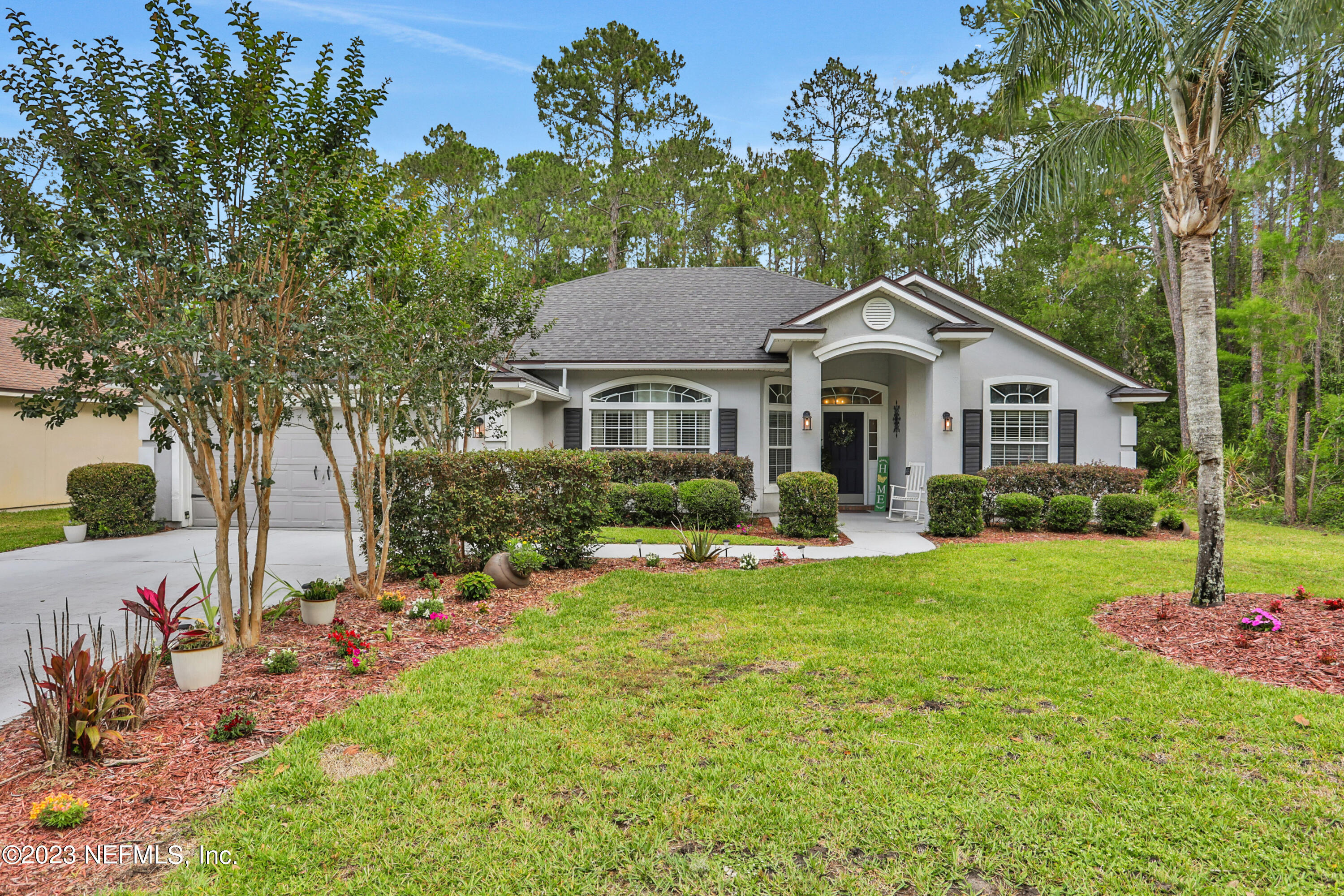 4100 Lonicera Loop St. Johns, FL 32259 - Photo 2 of 65 a front view of a house with a yard and trees