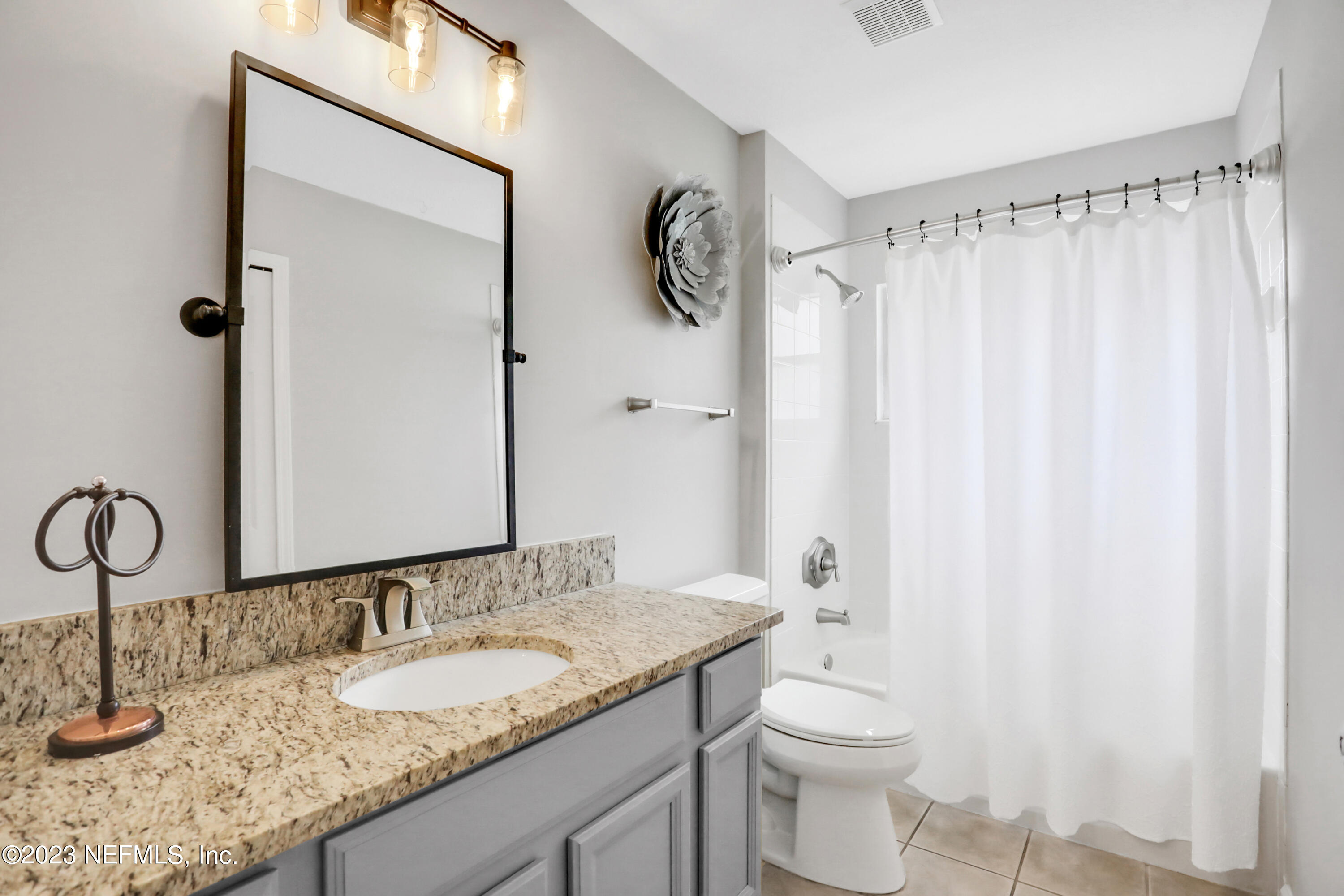 4100 Lonicera Loop St. Johns, FL 32259 - Photo 26 of 65 a bathroom with a granite countertop sink toilet and a mirror