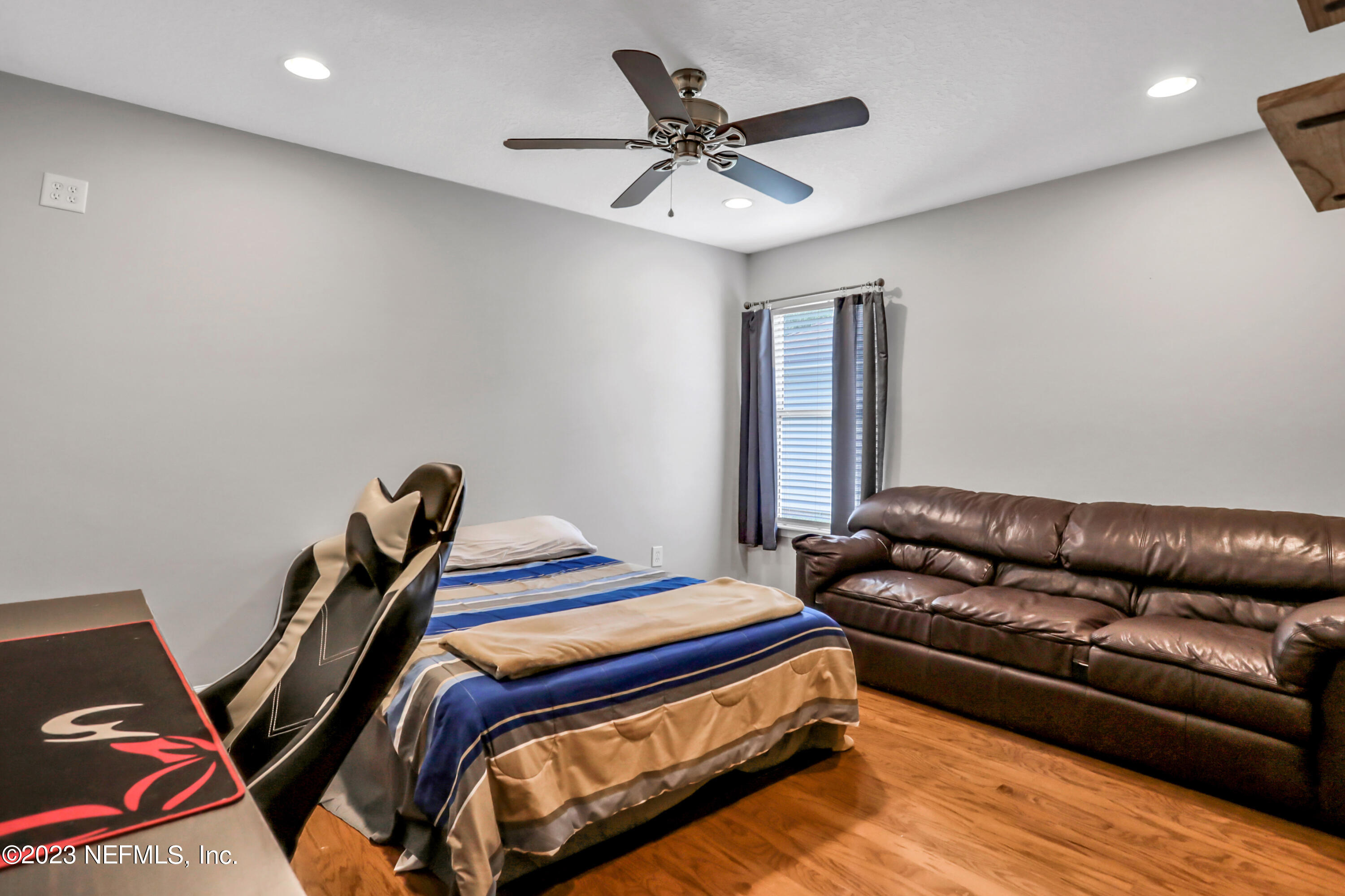 4100 Lonicera Loop St. Johns, FL 32259 - Photo 28 of 65 a bedroom with a bed and a couch