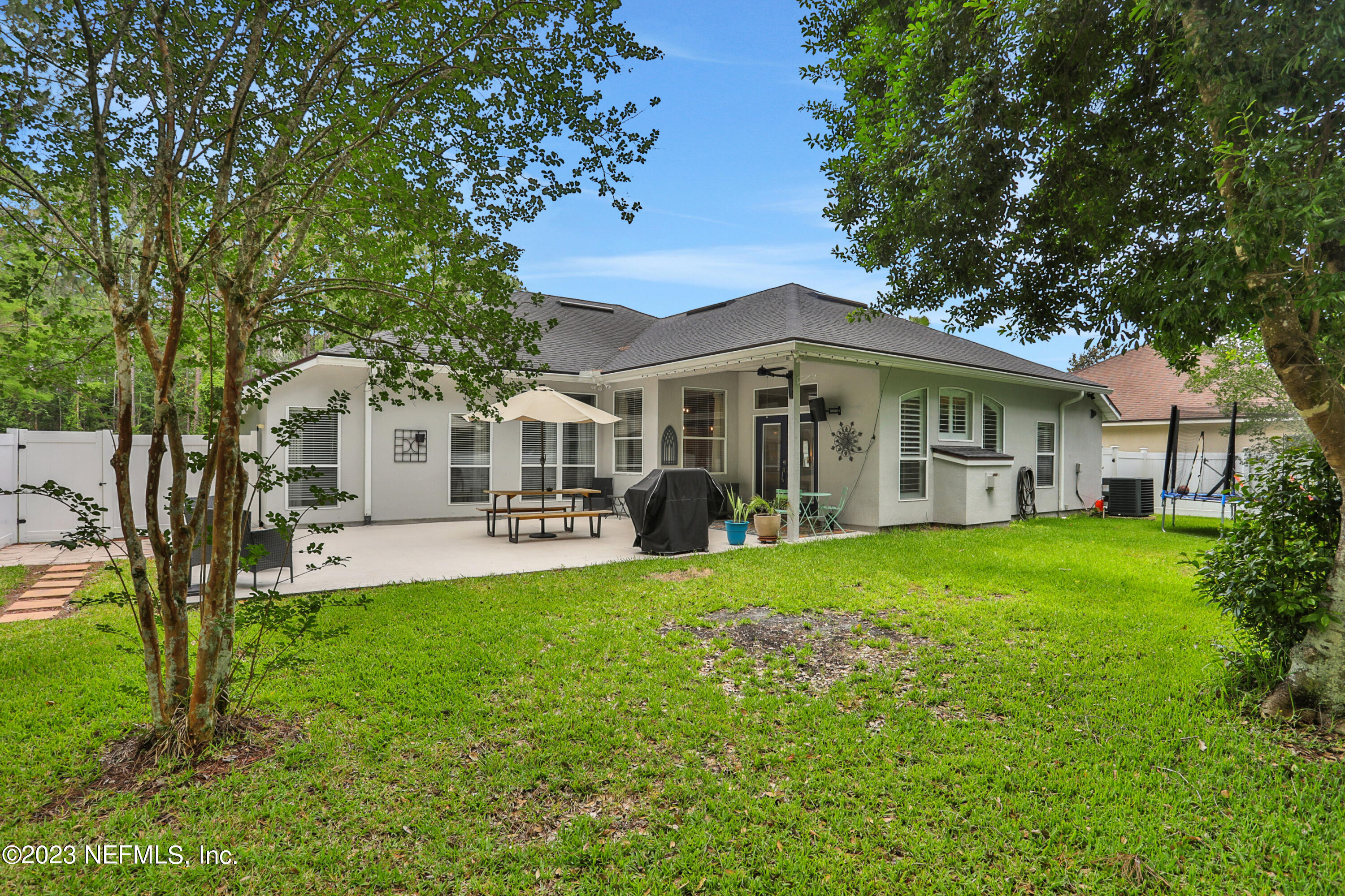4100 Lonicera Loop St. Johns, FL 32259 - Photo 32 of 65 a view of a house with a yard deck and a large tree