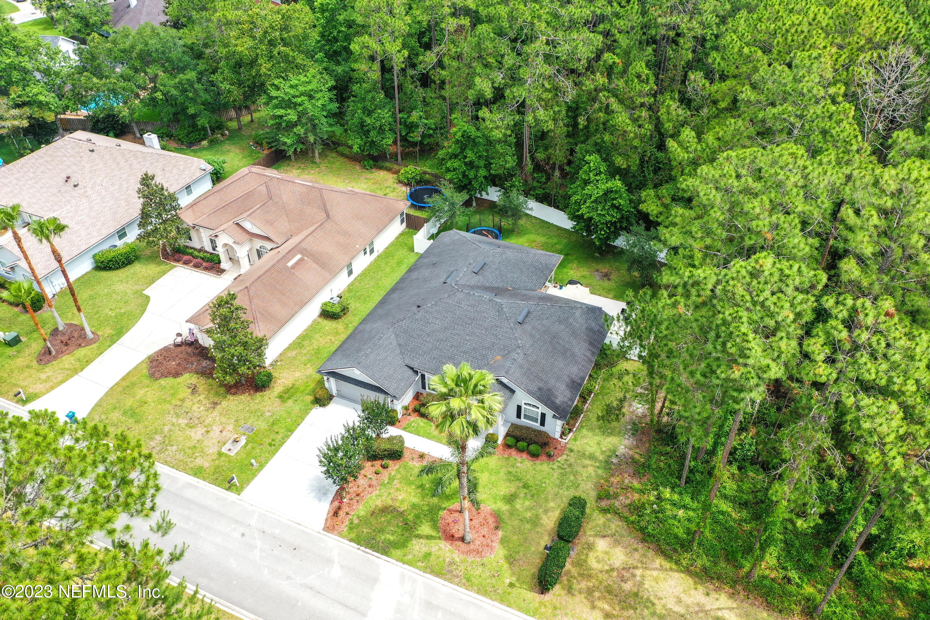 4100 Lonicera Loop St. Johns, FL 32259 - Photo 40 of 65 an aerial view of a house with a yard and lake view