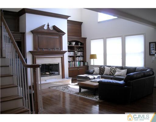 1 Barton Way Basking Ridge, NJ 07920 - Photo 3 of 20 a living room with furniture a fireplace and a flat screen tv
