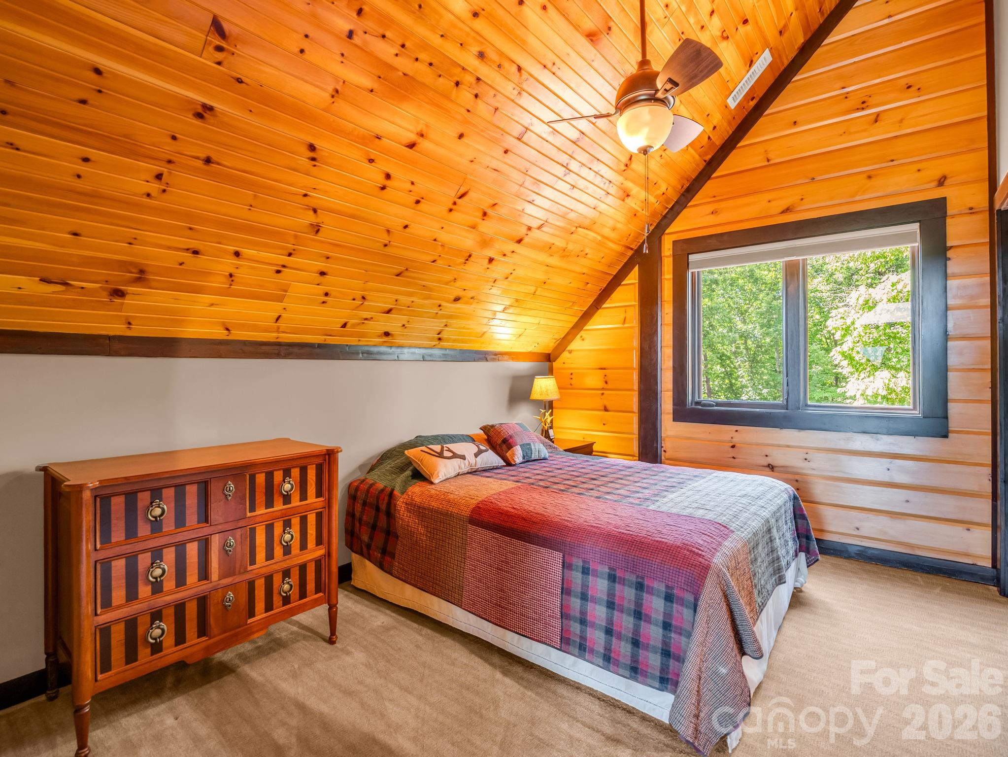 590 Boulder Ridge Lake Lure, NC 28746 - Photo 28 of 48 a bedroom with a bed and a window