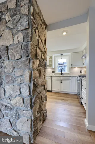 a large kitchen with cabinets and wooden floor