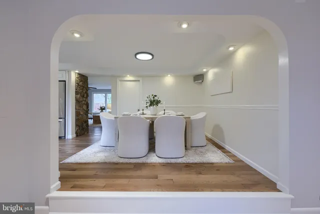 a dining room with a table and chairs
