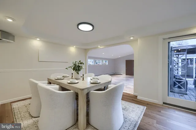 a dining room with furniture and wooden floor