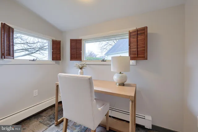 a spacious bedroom with a large bed and a large window