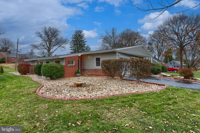 a house view with a sitting space and garden