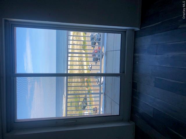 2 Richmond Road, Unit 6F Lido Beach, NY 11561 - Photo 6 of 14 Doorway with hardwood / wood-style flooring and view of water and beach