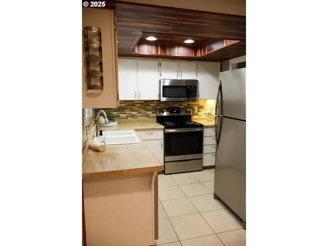 a kitchen with stainless steel appliances a stove and a refrigerator