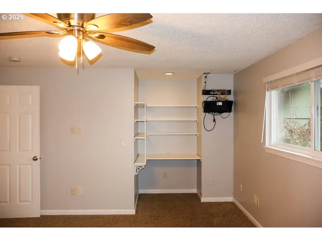 a view of empty room with a ceiling fan
