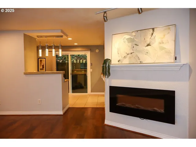 a living room with a fireplace and a floor to ceiling window