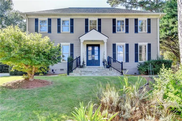 a front view of a house with garden